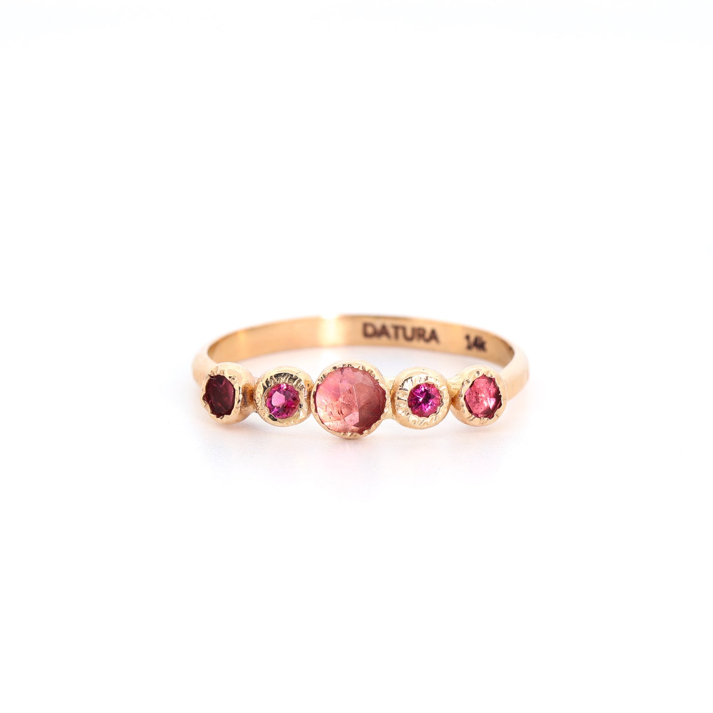 Gold ring with colorful gemstones on a white background