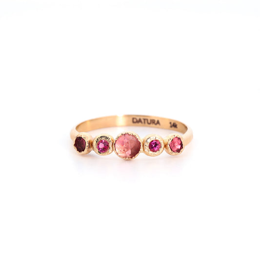 Gold ring with colorful gemstones on a white background